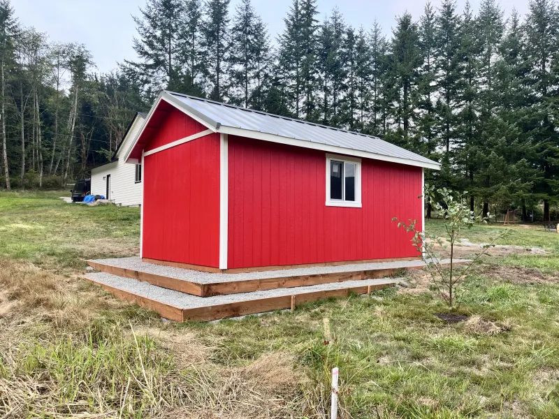 Red shed on gravel foundation pad